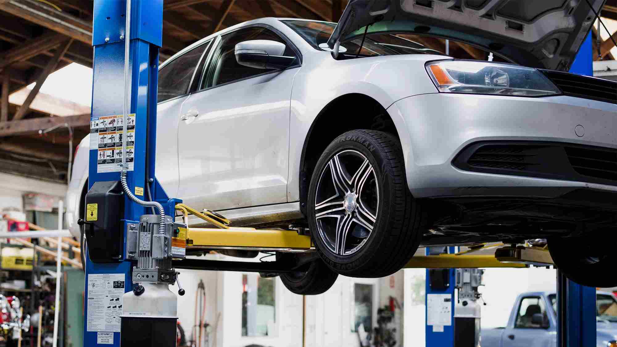 Reliable car mechanic inspecting engine